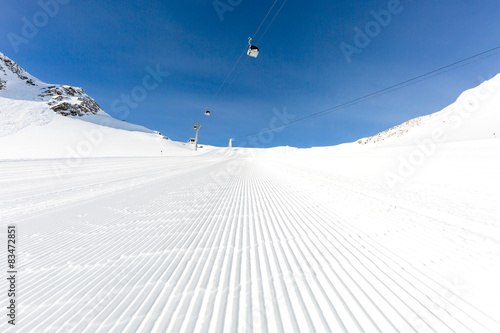 Newly groomed ski slope on a sunny day photo