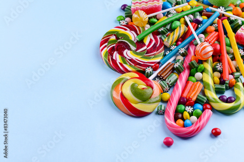 Colorful candies on light blue background