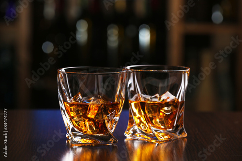 Fototapeta Naklejka Na Ścianę i Meble -  Glasses of whiskey on bar background