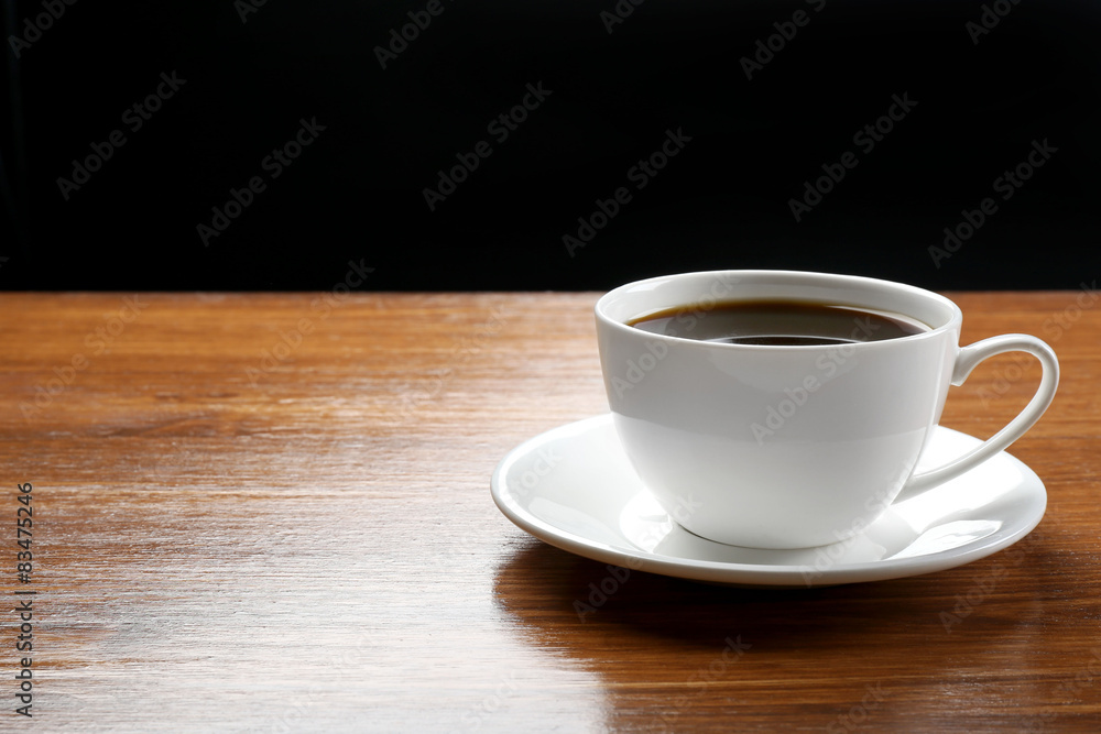 Cup of coffee on table on dark background Cup of coffee on table on dark background