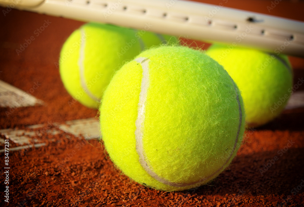 Close up view of tennis racket and balls