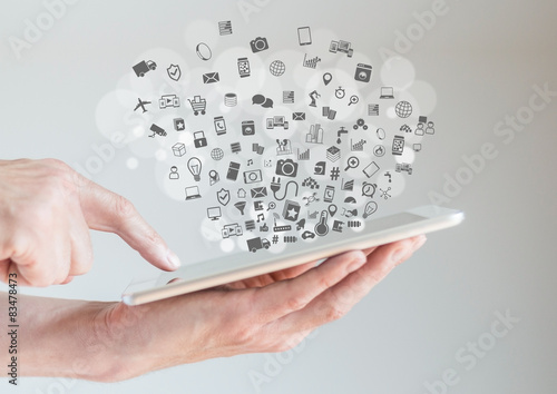 Internet of things (IoT) concept with hands holding tablet