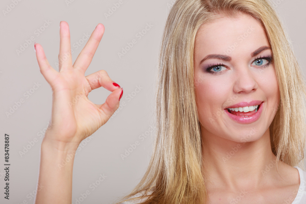 Woman showing ok hand sign gesture Woman showing ok hand sign gesture