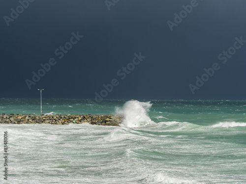 A huge wave breaks on Cottesloe groyne, Perth, during a storm photo