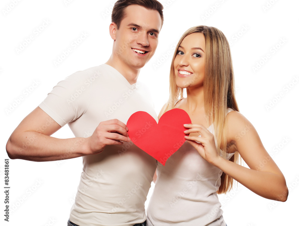 Happy couple in love holding red heart Happy couple in love holding red heart