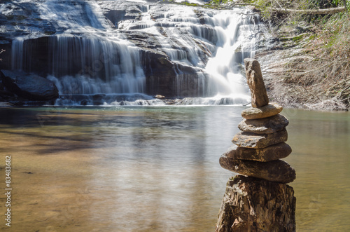 Cairn at the bottom of waterfall photo