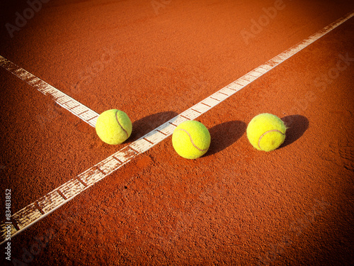 Tennis balls on a tennis clay court