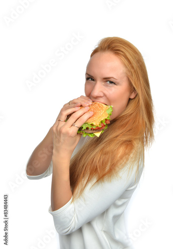 Fast food concept. Woman eating tasty unhealthy burger sandwich