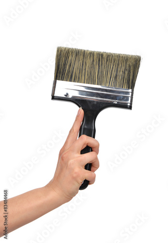 Woman hand with aint brush with plastic black handle i