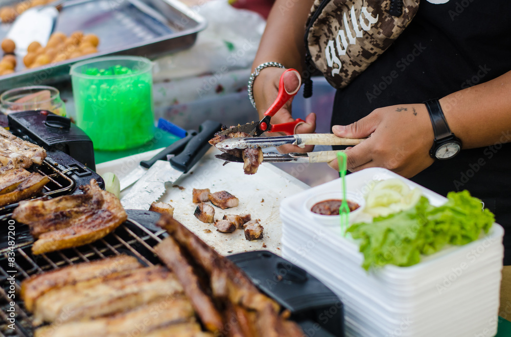 grilling pork in market . grilling pork in market .