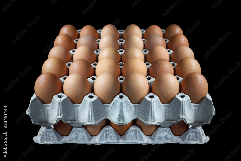 Eggs in paper tray on black background