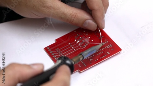 Man soldering electronic parts - closeup photo