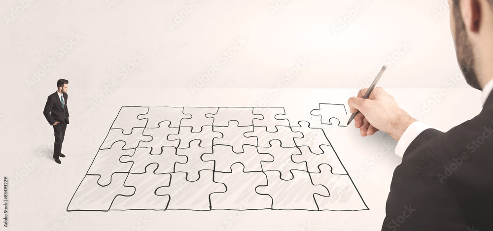 Business man looking at hand drawing solution Business man looking at hand drawing solution