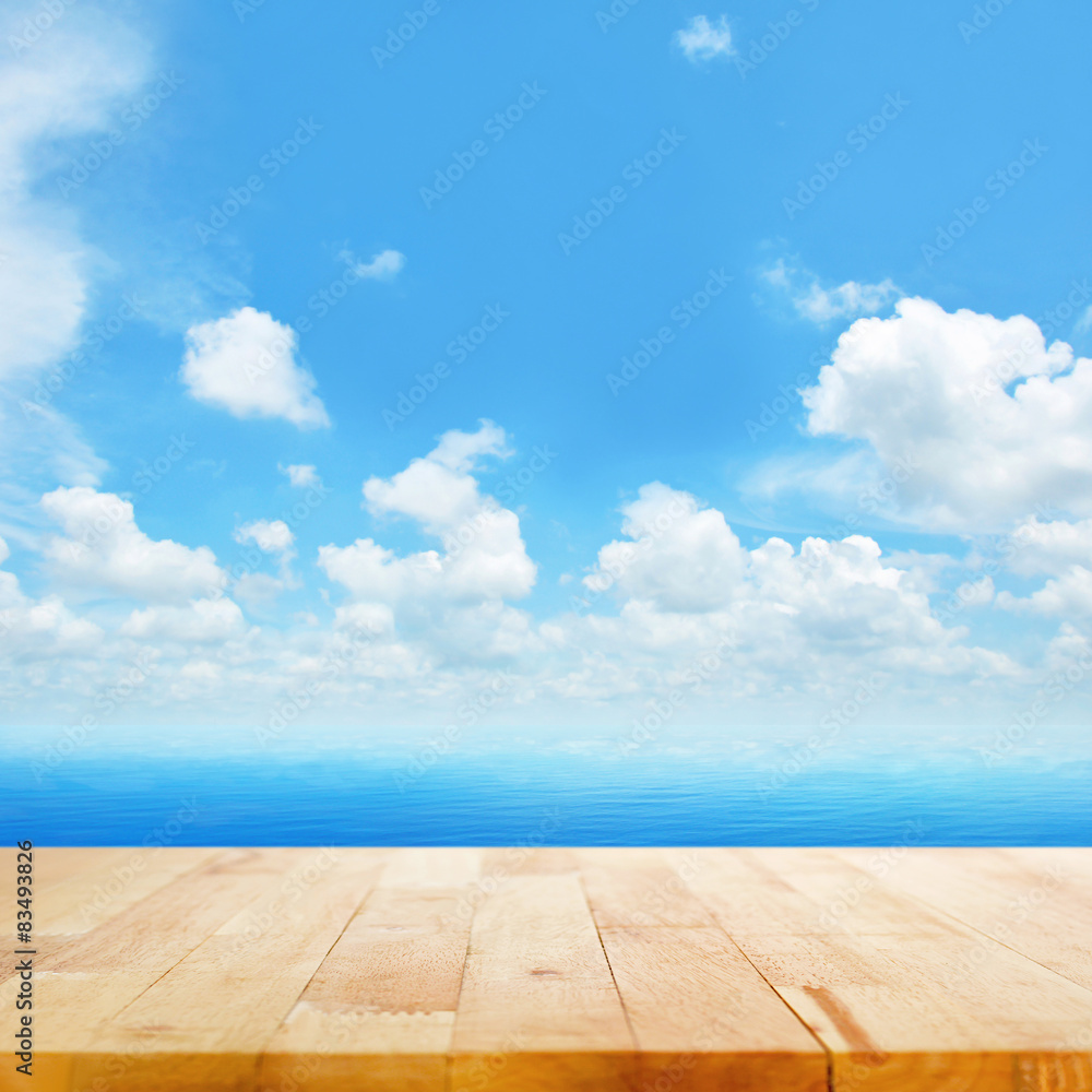 Wood table top on blue sea water and  bright summer sky backgrou