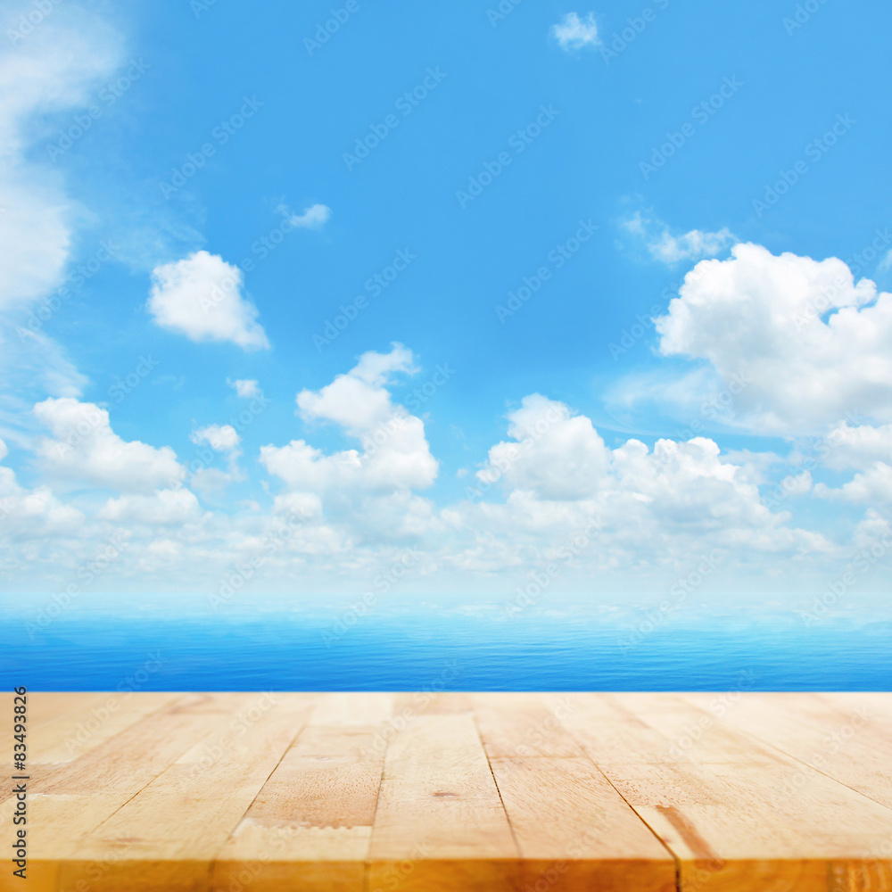 Wood table top on blue sea water and bright summer sky backgrou Wood table top on blue sea water and bright summer sky backgrou