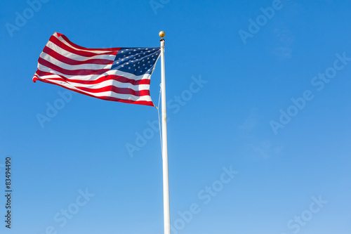 American flag against blue sky.