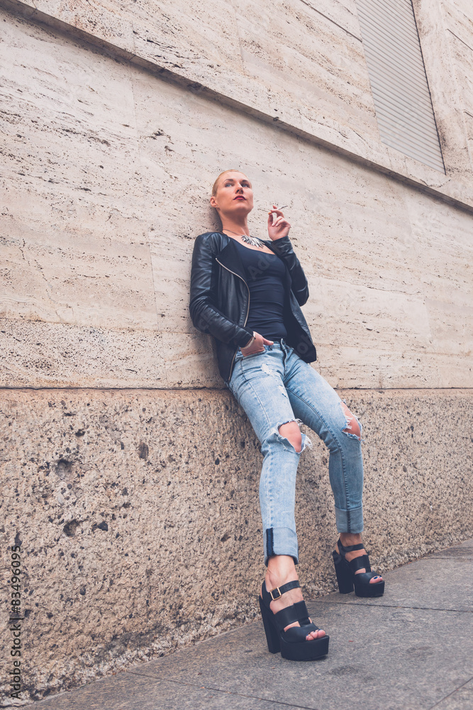 Beautiful girl smoking in the city streets Beautiful girl smoking in the city streets