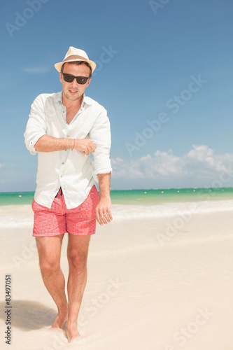  young man walking on the beach