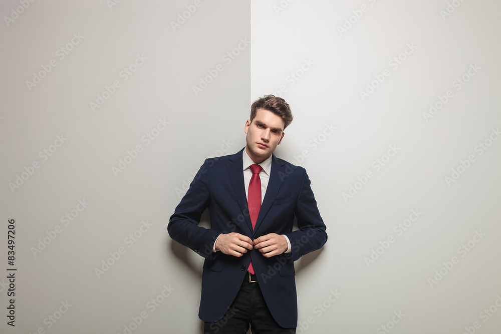 young handsome business man closing his jacket. young handsome business man closing his jacket.