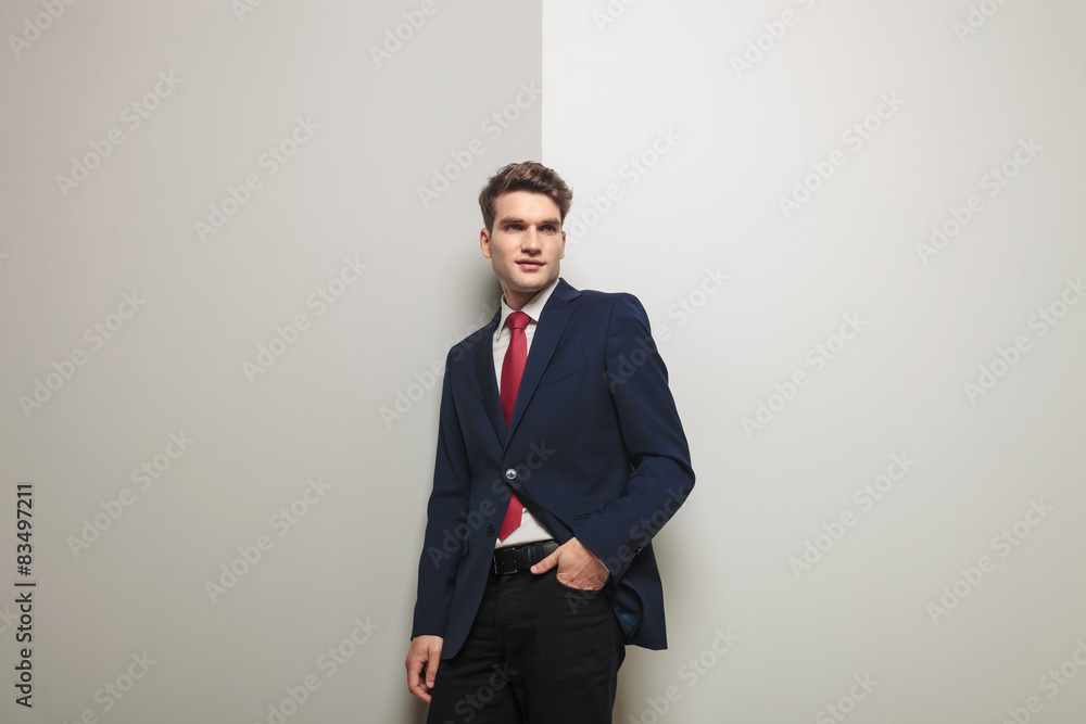 Young business man holding one hand in his pocket Young business man holding one hand in his pocket