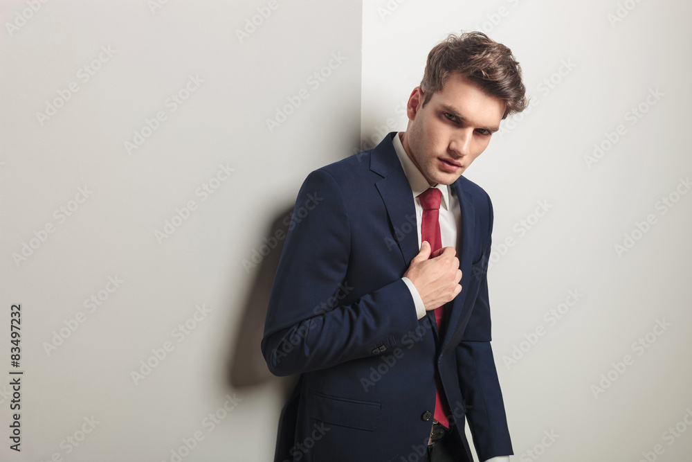 successful young business man fixing his tie. successful young business man fixing his tie.