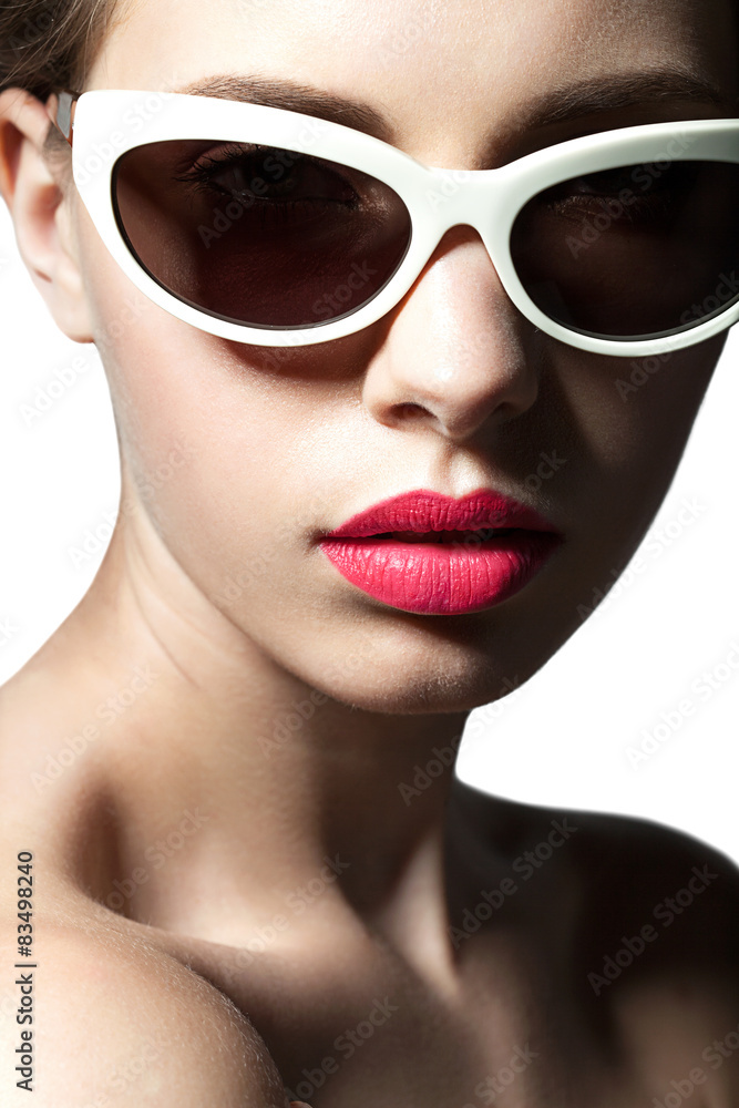 Fashion model close up in sunglasses on white background Fashion model close up in sunglasses on white background