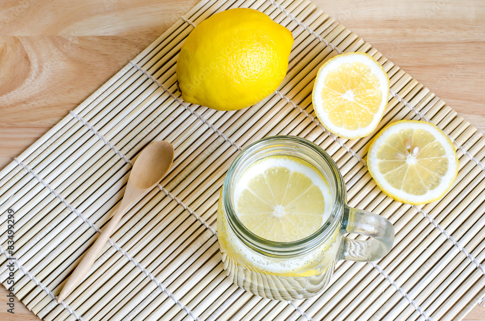 Soda with lemon in jar on wooden table Soda with lemon in jar on wooden table