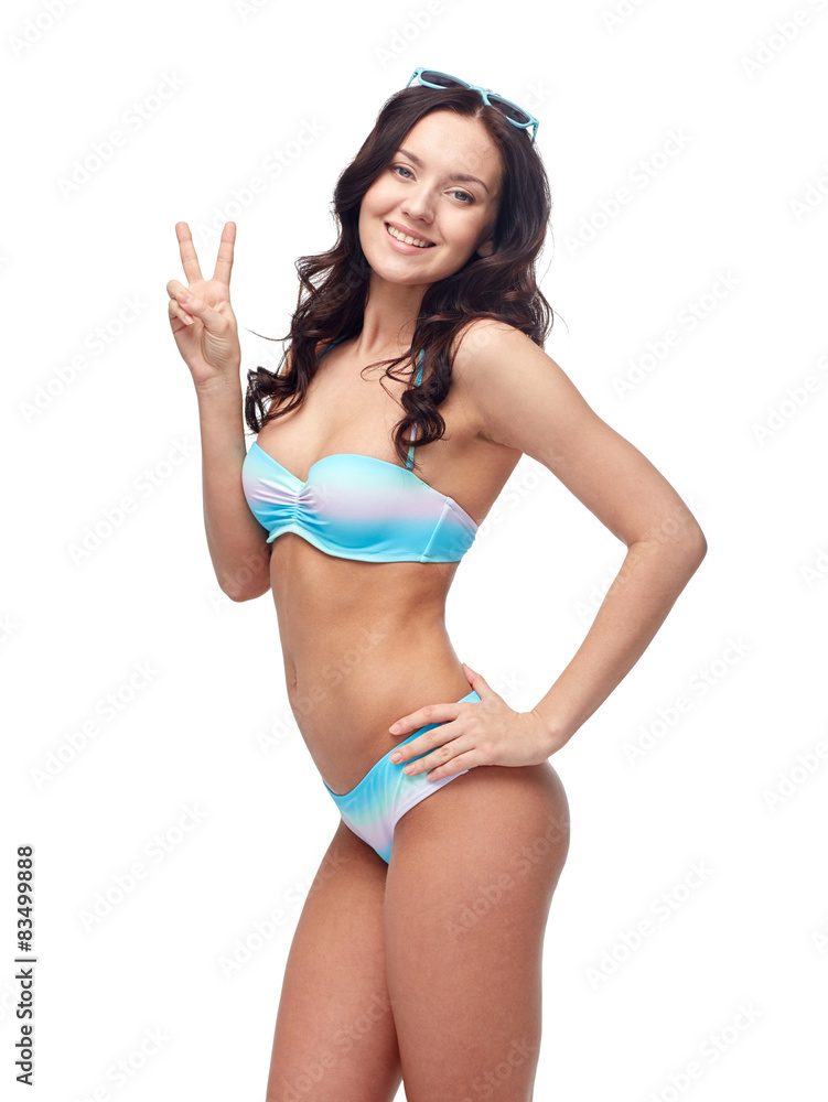 happy woman in swimsuit showing victory hand sign happy woman in swimsuit showing victory hand sign