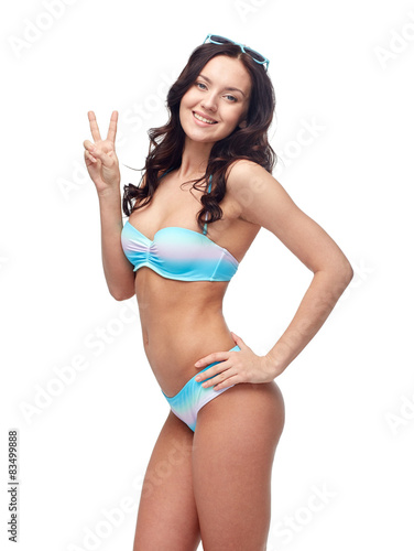 happy woman in swimsuit showing victory hand sign © Syda Productions