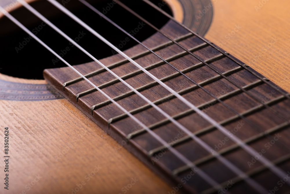 Closeup of old guitar body with sound hole and strings Closeup of old guitar body with sound hole and strings