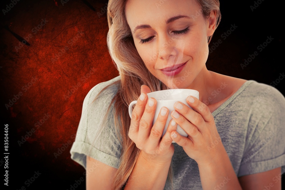 Composite image of smiling blonde with hot beverage relaxing Composite image of smiling blonde with hot beverage relaxing