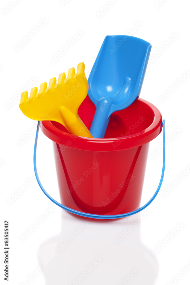 Toy bucket rake and spade isolated on white background Toy bucket rake and spade isolated on white background