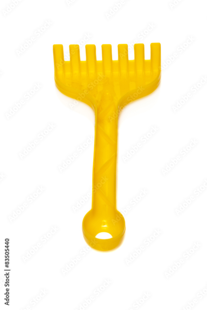 Yellow rake toy isolated on white background Yellow rake toy isolated on white background