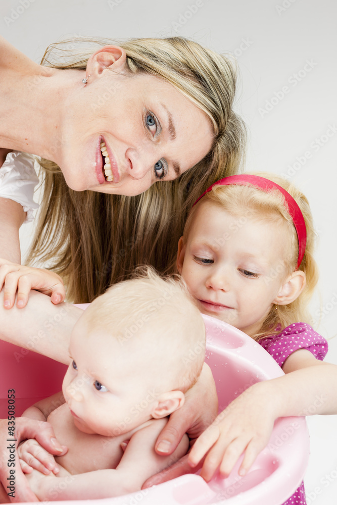 portrait of mother with her baby and daughter during bathing portrait of mother with her baby and daughter during bathing