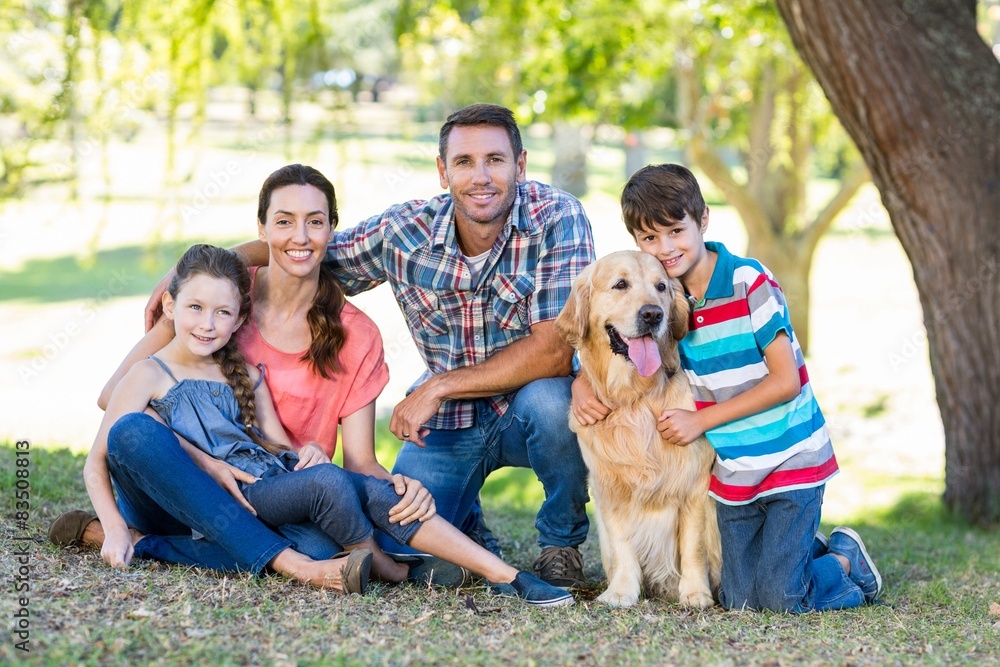 Fototapeta premium Happy family with their dog in the park