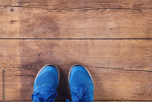 Legs of a runner. Studio shot on wooden background.