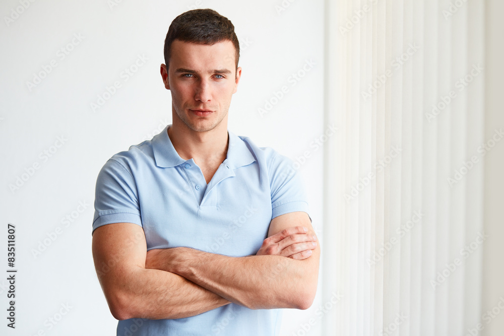 Young businessman standing in an office Young businessman standing in an office