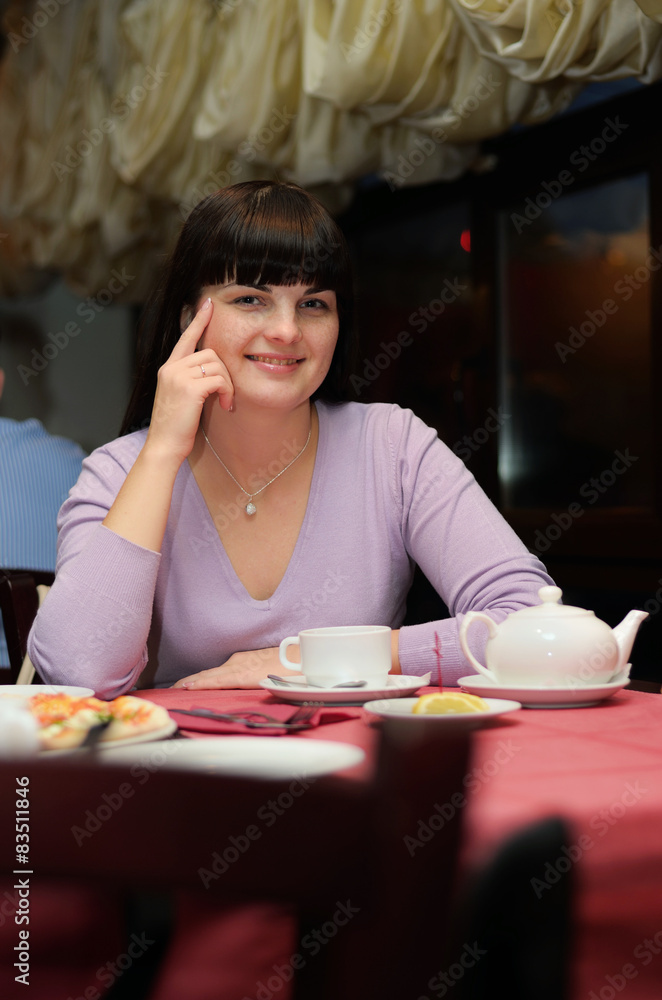 Girl sit in cafe and drink tea