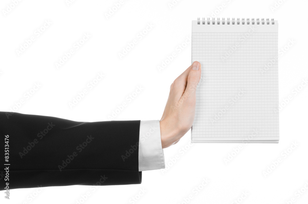 hand of a journalist in a black suit holding a notebook hand of a journalist in a black suit holding a notebook
