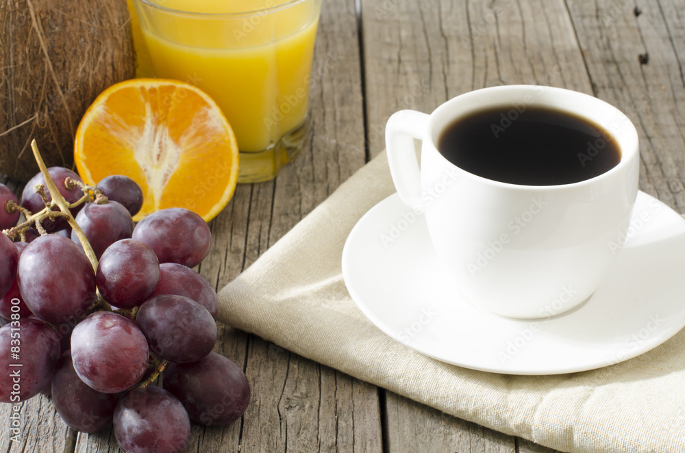 cup of coffee on a wooden table with nut, grapes, orange juice cup of coffee on a wooden table with nut, grapes, orange juice