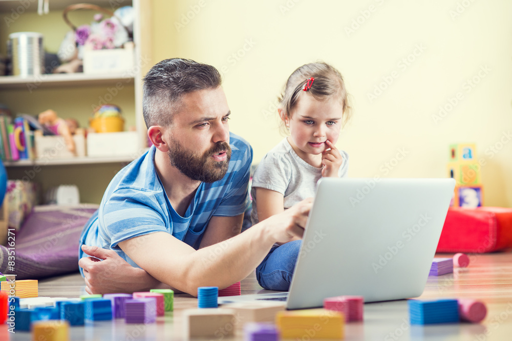Young father spending time with his little daughter at home Young father spending time with his little daughter at home