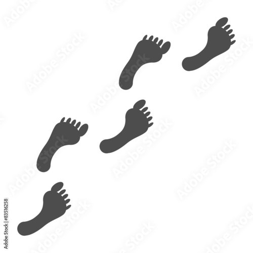 Trail of black human bare footsteps