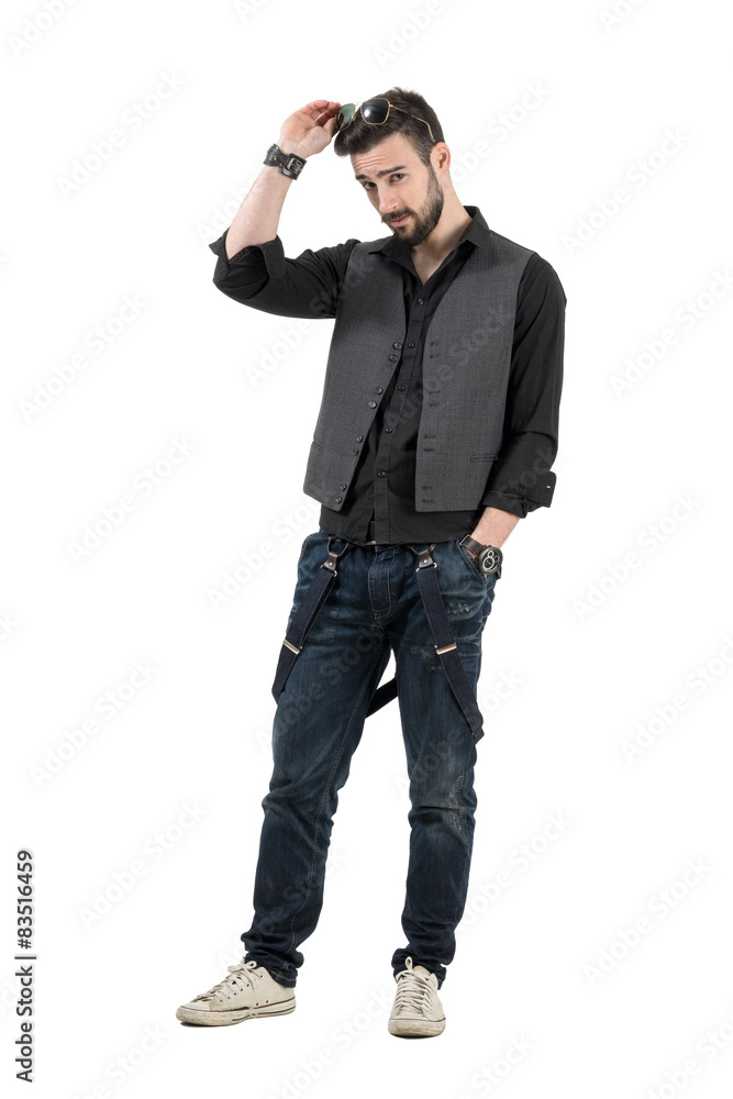 Bearded young man putting sunglasses on his head Bearded young man putting sunglasses on his head