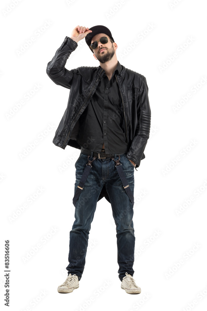 Bearded man wearing sunglasses holding baseball cap Bearded man wearing sunglasses holding baseball cap