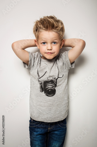Little pretty boy posing at studio as a fashion model 