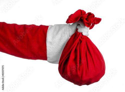 Santa holding a big red sack with gifts on white background photo