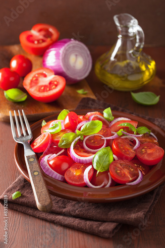 healthy tomato salad with onion basil olive oil and balsamic vin