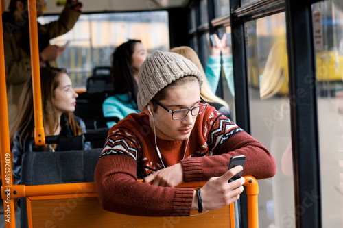 man rides a bus, listening to music