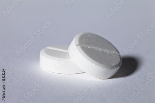 Close-up of Two White pills on a table