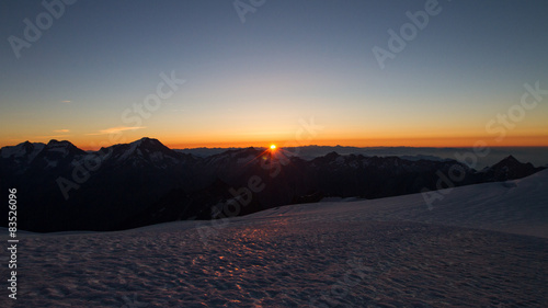 Switzerland, Allalinhorn, The Alps, Wallis, View of snowcapped mountains at sunrise photo